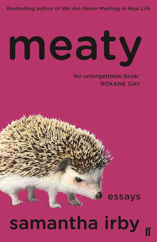 The book cover for Meaty has a dark pink background with an angry hedgehog glaring at the viewer. The title and author's name are written in black.