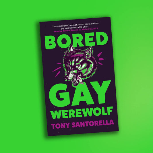 A black hardback book with an illustration of a werewolf head, surrounded by green text that reads "Bored Gay Werewolf".