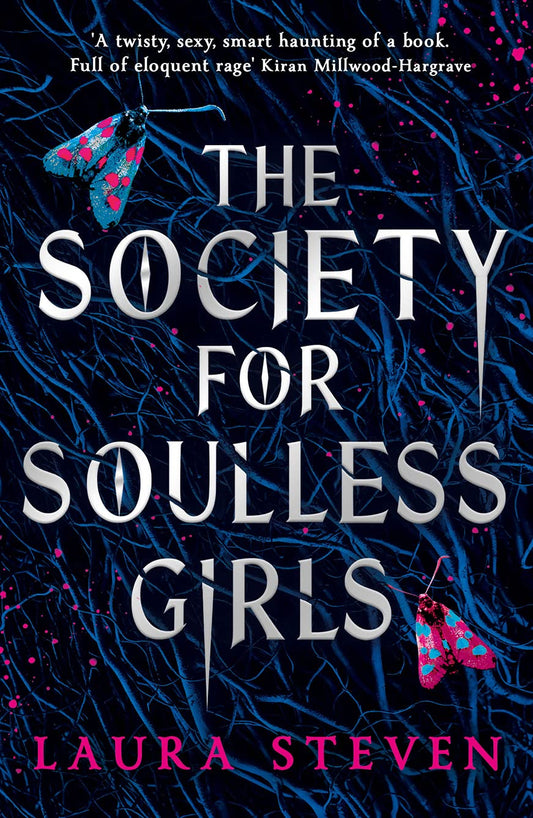 Blue tree branches on a dark background interlock with the title "The Society For Soulless Girls". Two months, one pink with blue dots and the other blue with pink dots, sit atop the branches.