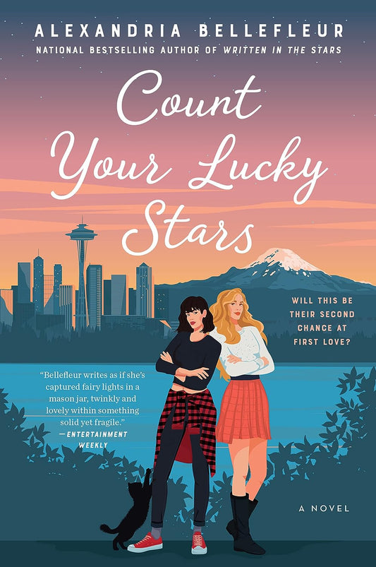 The book cover for Count Your Lucky Stars shows the Seattle skyline at dawn. Two white women stand side by side, with a black cat at their feet. Yellow text reads "Will this be their second chance at first love?"