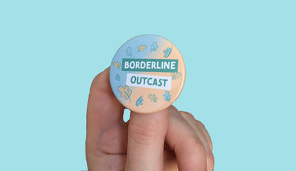 A badge with the text "Borderline Outcast" and blue and peach leaves.