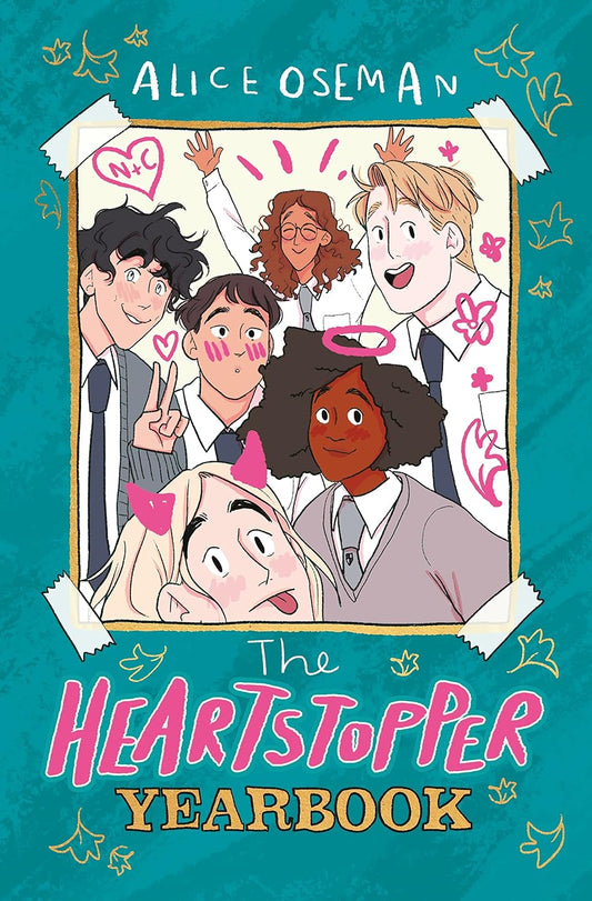 The blue book cover for The Heartstopper Yearbook has a photo of a group of diverse British teenagers sellotaped to the front. Outlines of gold leaves are etched into the cover.