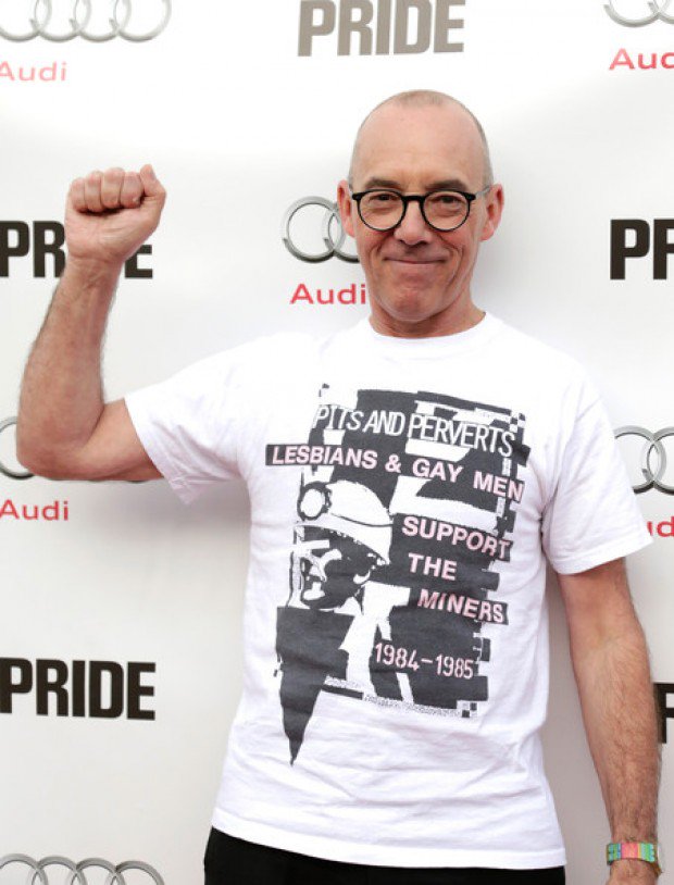 Mike Jackson, a white gay man, wears the Pits and Perverts t-shirt while raising his first in the air - fight the power!