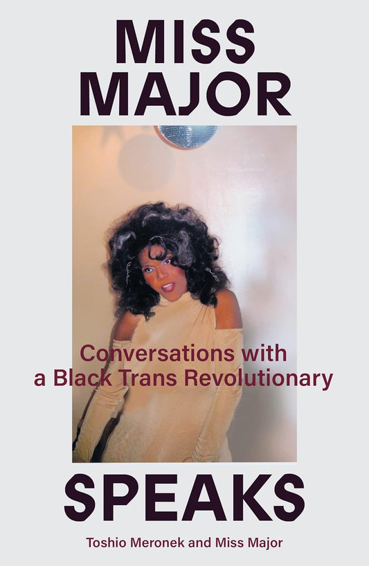 The white book cover for Miss Major Speaks has a picture of Miss Major, a black lady in a gold dress with big, black hair, stood under a disco ball.