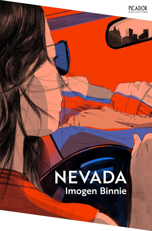 The book cover for Nevada - a lady wearing sunglasses and a red shirt drives towards the mountains, the city she's leaving behind reflected in her rearview mirror.