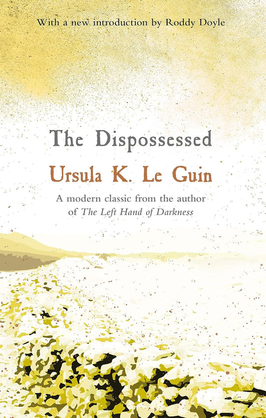 The white book cover for Dispossessed has a small wall that divides the land in two.