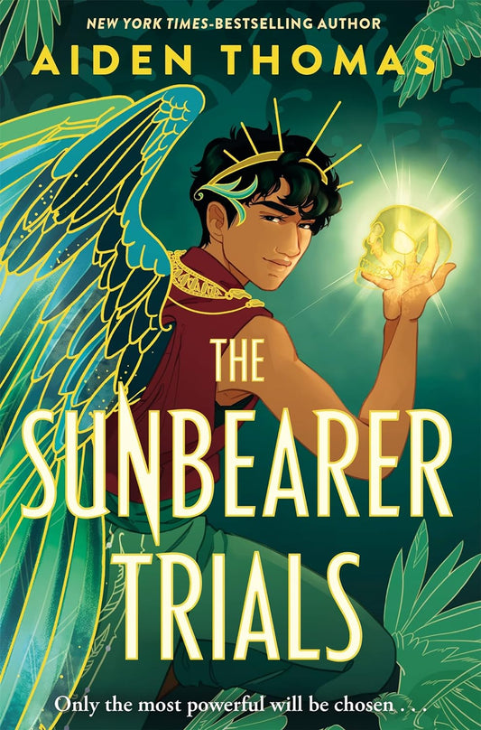 The book cover for The Sunbearer Trials shows a Mexican teenage boy with wings protruding from his back, with a crown on his head and holding a golden, glowing skull in his right hand.