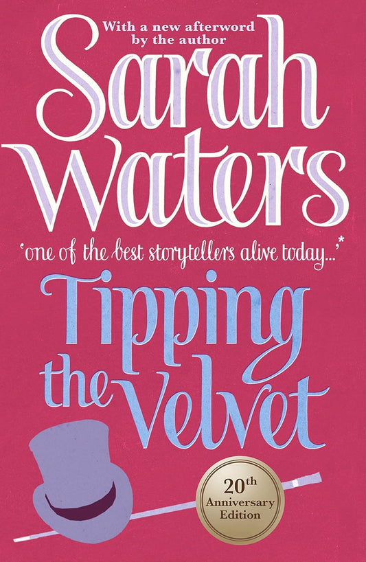 The book cover for Tipping the Velvet has a purple top hat and baton at the base of the cover under the title. A gold sticker on the cover reads "20th Anniversary Edition". 