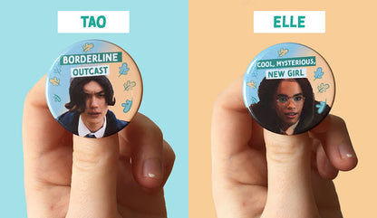 Heartstopper characters Tao and Elle are printed on their own individual badges. Tao is a British East Asian teen boy and there is text that says “Borderline Outcast” on his badge. Elle is a Black trans teen girl and there is text that says “Cool, mysterious, new girl” on her badge. 